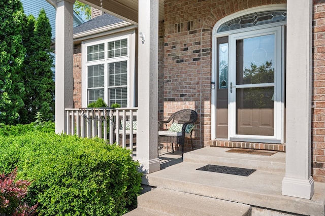 1826 Joseph Sixbury St, Sycamore, IL 60178 - doorway to property with a porch and brick siding