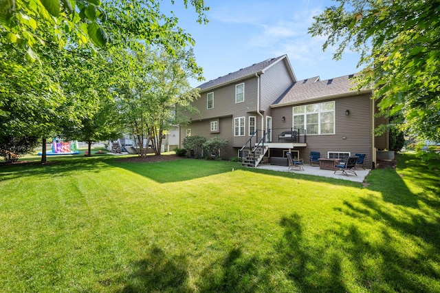 1826 Joseph Sixbury St, Sycamore, IL 60178 - back of house with a patio area, stairs, a wooden deck, a lawn, and a playground