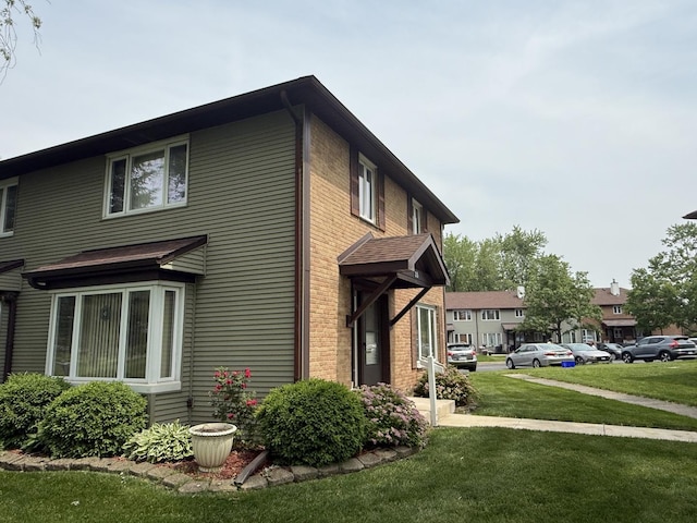 215 Krotiak Rd, Park Forest, IL 60466 - view of side of home featuring a yard and brick siding