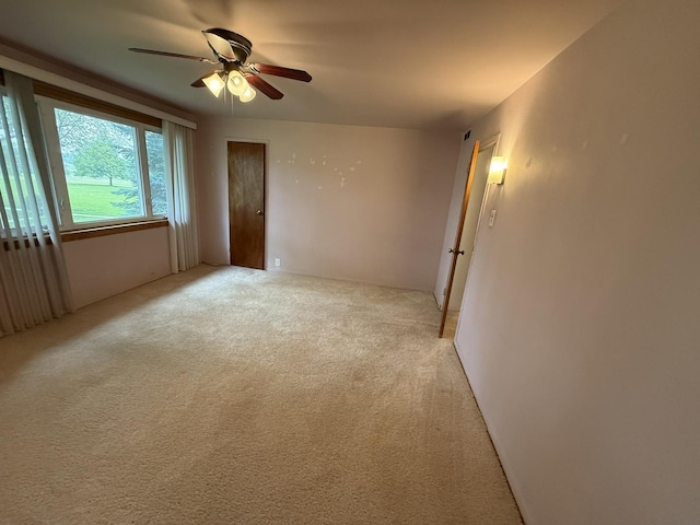 215 Krotiak Rd, Park Forest, IL 60466 - spare room featuring a ceiling fan and light carpet
