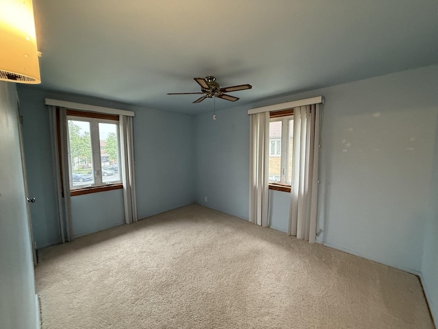 215 Krotiak Rd, Park Forest, IL 60466 - carpeted empty room with plenty of natural light and a ceiling fan