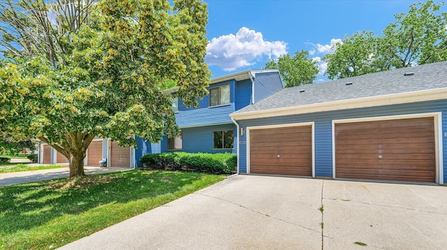 2553 Clayton Blvd Unit 2553, Champaign, IL 61822 - view of front facade featuring concrete driveway, a front yard, an attached garage, and a shingled roof