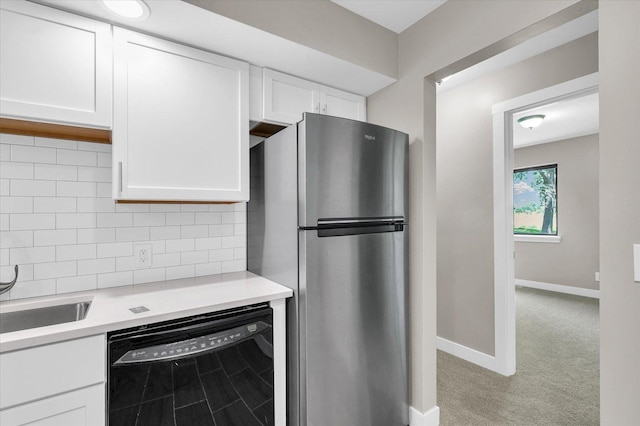2553 Clayton Blvd Unit 2553, Champaign, IL 61822 - kitchen featuring black dishwasher, freestanding refrigerator, light countertops, white cabinets, and decorative backsplash