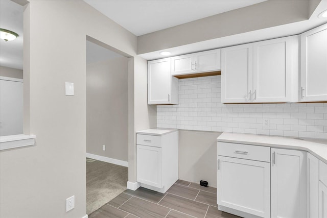 2553 Clayton Blvd Unit 2553, Champaign, IL 61822 - kitchen with white cabinetry, decorative backsplash, light countertops, and wood finish floors