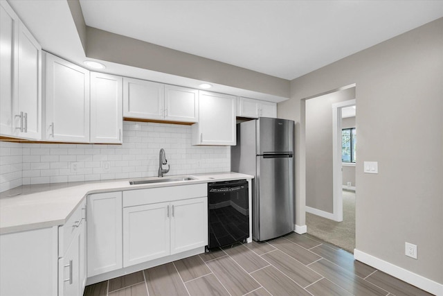 2553 Clayton Blvd Unit 2553, Champaign, IL 61822 - kitchen with black dishwasher, freestanding refrigerator, light countertops, and white cabinetry
