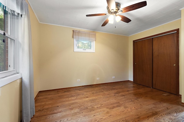 25725 S Old Monee Steger Rd, Monee, IL 60449 - unfurnished bedroom with crown molding, wood finished floors, a closet, and ceiling fan