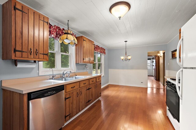 25725 S Old Monee Steger Rd, Monee, IL 60449 - kitchen featuring white appliances, brown cabinetry, a chandelier, light countertops, and light wood-style floors
