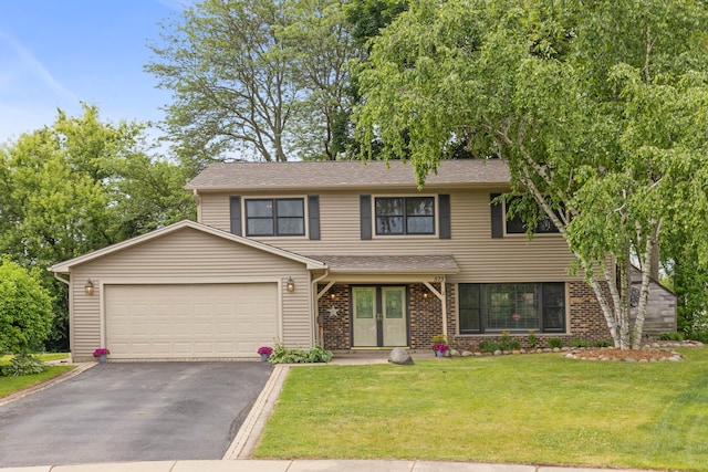 573 Surryse Rd, Lake Zurich, IL 60047 - view of front facade with driveway, a garage, a front yard, and brick siding