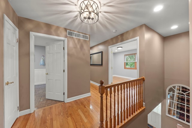 573 Surryse Rd, Lake Zurich, IL 60047 - corridor with an upstairs landing, light wood-style flooring, recessed lighting, and a chandelier