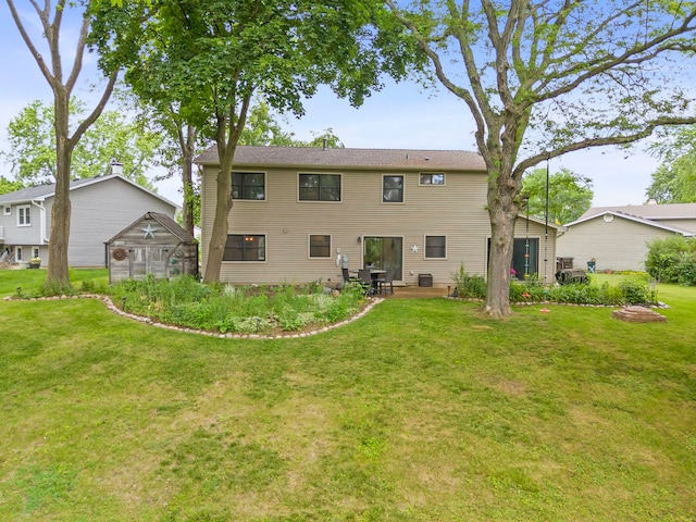 573 Surryse Rd, Lake Zurich, IL 60047 - back of property with a yard, an exterior structure, an outbuilding, and a patio area