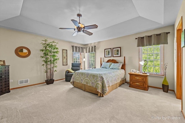 3720 Cypress Dr, Spring Grove, IL 60081 - bedroom featuring light carpet, multiple windows, a raised ceiling, and ceiling fan