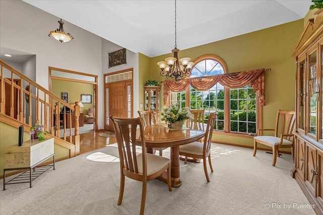 3720 Cypress Dr, Spring Grove, IL 60081 - dining room with carpet, high vaulted ceiling, a chandelier, and stairway