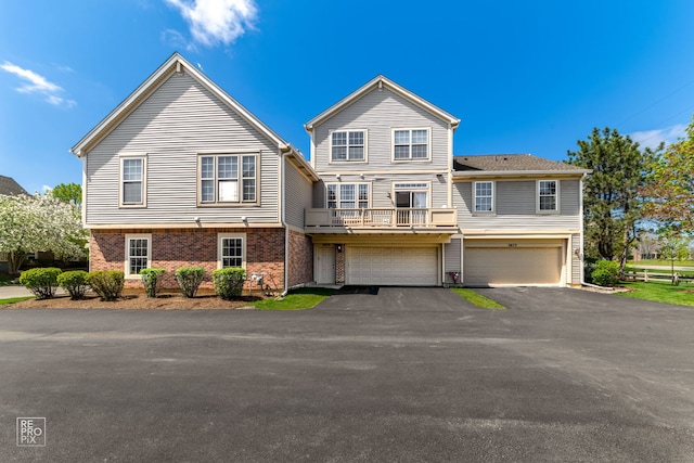 2673 N Greenwood Ave, Arlington Heights, IL 60004 - townhome / multi-family property with a balcony, an attached garage, asphalt driveway, and brick siding