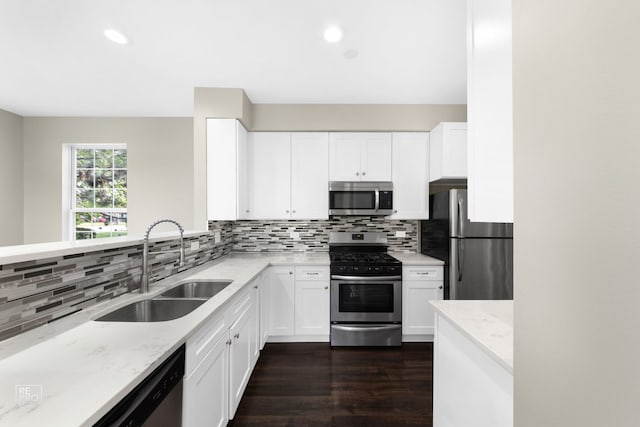 2673 N Greenwood Ave, Arlington Heights, IL 60004 - kitchen with appliances with stainless steel finishes, light stone countertops, dark wood-type flooring, backsplash, and white cabinets