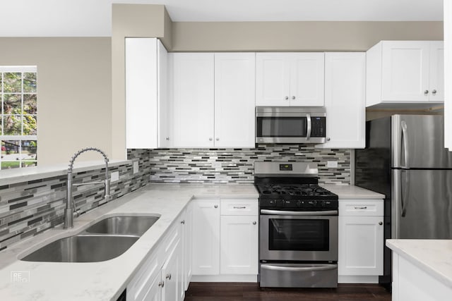 2673 N Greenwood Ave, Arlington Heights, IL 60004 - kitchen featuring appliances with stainless steel finishes, light stone countertops, dark wood-style floors, white cabinets, and backsplash