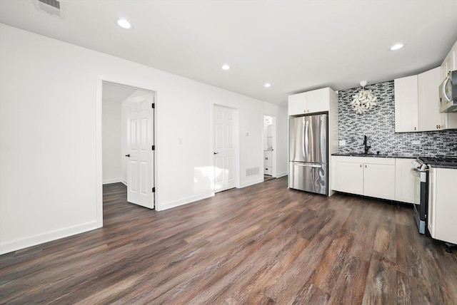 12629 S Throop St, Calumet Park, IL 60827 - kitchen with appliances with stainless steel finishes, dark countertops, decorative backsplash, dark wood-type flooring, and white cabinetry