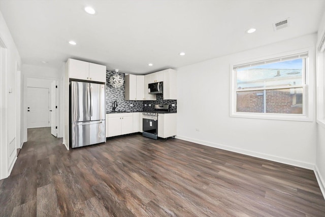 12629 S Throop St, Calumet Park, IL 60827 - kitchen with stainless steel appliances, dark wood-type flooring, backsplash, white cabinets, and recessed lighting