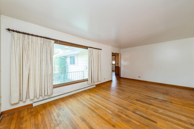 184 Kathleen Dr, Elgin, IL 60123 - spare room featuring a baseboard heating unit and hardwood / wood-style flooring