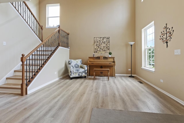 60 Linden Rd, Lake Zurich, IL 60047 - living area featuring a high ceiling, wood finished floors, and stairway