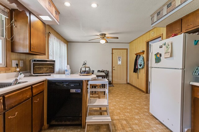 103 Taylor Ct, Catlin, IL 61817 - kitchen with black dishwasher, freestanding refrigerator, a peninsula, light countertops, and ceiling fan