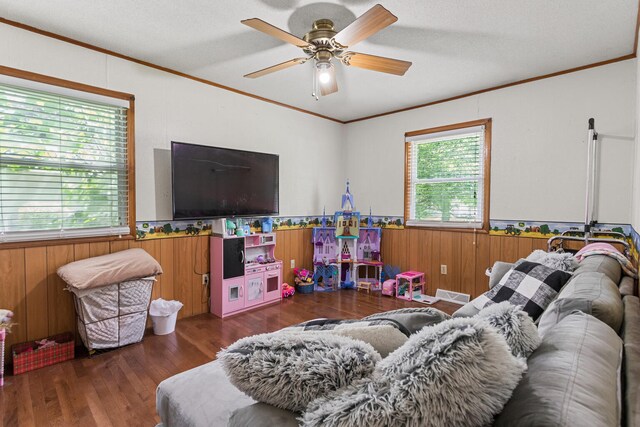 103 Taylor Ct, Catlin, IL 61817 - living area with wainscoting, crown molding, ceiling fan, wood finished floors, and wooden walls