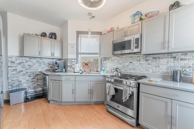 3605 W Cermak Rd, Chicago, IL 60623 - kitchen featuring appliances with stainless steel finishes, gray cabinets, and light wood finished floors