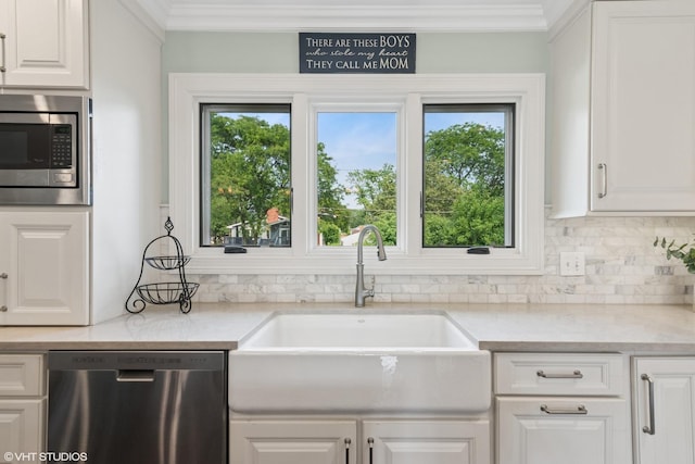 769 S Stuart Ave, Elmhurst, IL 60126 - kitchen with stainless steel appliances, backsplash, white cabinetry, healthy amount of natural light, and ornamental molding