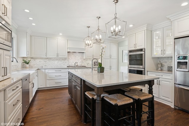 769 S Stuart Ave, Elmhurst, IL 60126 - kitchen with stainless steel appliances, a chandelier, white cabinets, backsplash, and recessed lighting