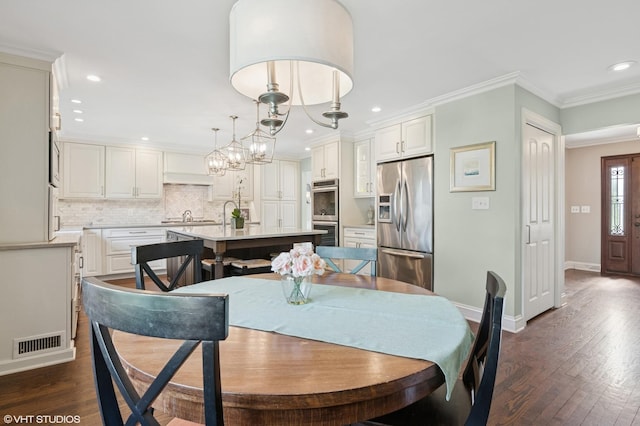 769 S Stuart Ave, Elmhurst, IL 60126 - dining area featuring recessed lighting, dark wood-style flooring, crown molding, and a chandelier