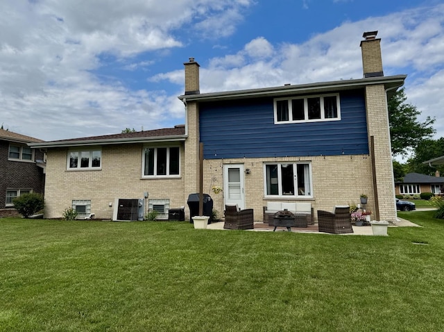 769 S Stuart Ave, Elmhurst, IL 60126 - back of property with a chimney, a lawn, and brick siding