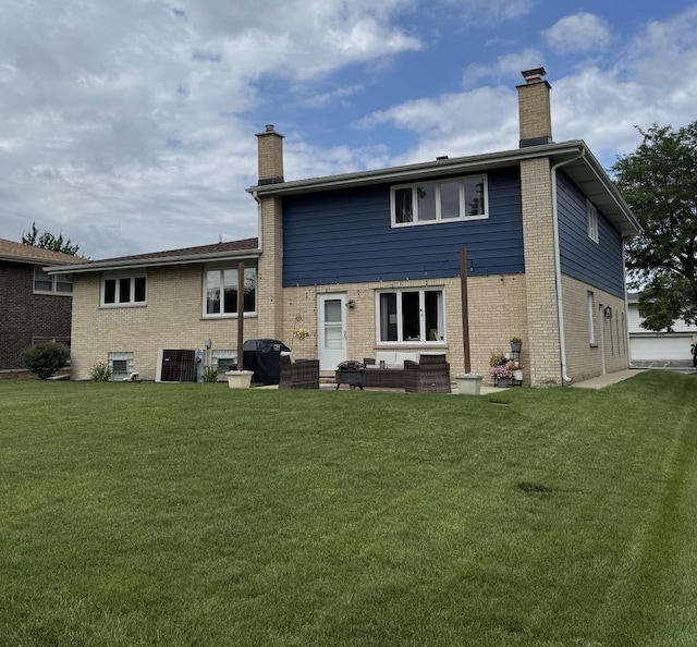 769 S Stuart Ave, Elmhurst, IL 60126 - rear view of property featuring a chimney, a lawn, and brick siding