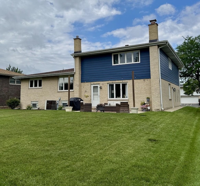 769 S Stuart Ave, Elmhurst, IL 60126 - back of house featuring a chimney, a lawn, and brick siding