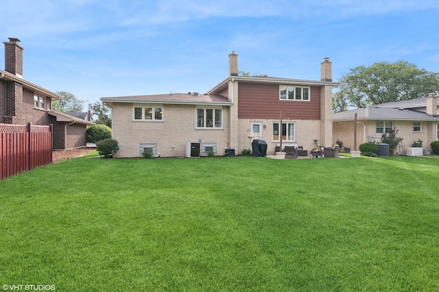 769 S Stuart Ave, Elmhurst, IL 60126 - rear view of property featuring brick siding, an outdoor living space, and a chimney