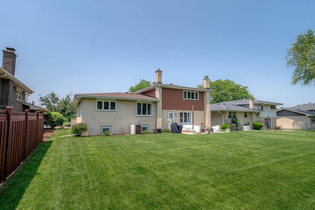 769 S Stuart Ave, Elmhurst, IL 60126 - back of house with a chimney and brick siding