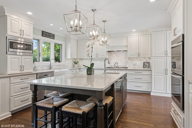 769 S Stuart Ave, Elmhurst, IL 60126 - kitchen featuring stainless steel appliances, a chandelier, white cabinetry, recessed lighting, and ornamental molding