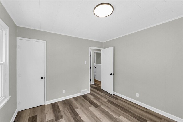 1211 Garden Ln, Champaign, IL 61820 - unfurnished bedroom with wood finished floors and ornamental molding