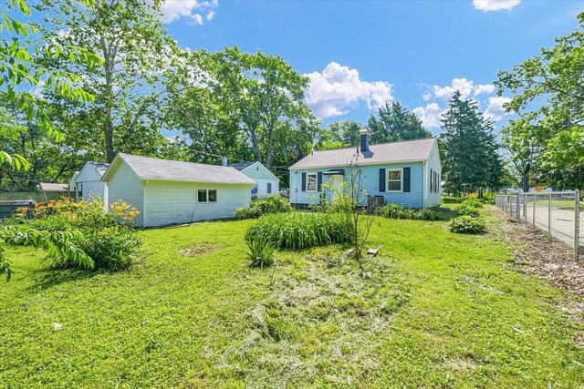 1211 Garden Ln, Champaign, IL 61820 - rear view of property with an outbuilding and a chimney