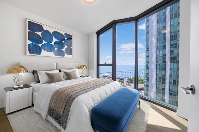 211 N Harbor Dr Unit 1601, Chicago, IL 60601 - bedroom featuring a water view, a wall of windows, and wood finished floors