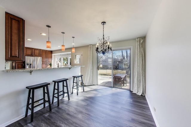 2023 N Shenandoah Dr, Arlington Heights, IL 60004 - kitchen with stainless steel fridge with ice dispenser, a breakfast bar area, a chandelier, dark wood finished floors, and recessed lighting