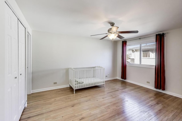2023 N Shenandoah Dr, Arlington Heights, IL 60004 - unfurnished bedroom with light wood-style floors, a closet, ceiling fan, and a nursery area