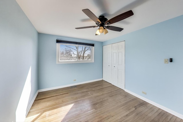 2023 N Shenandoah Dr, Arlington Heights, IL 60004 - unfurnished bedroom featuring wood-type flooring, a closet, and ceiling fan