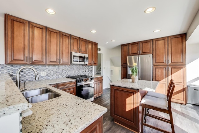 2023 N Shenandoah Dr, Arlington Heights, IL 60004 - kitchen with stainless steel appliances, brown cabinets, light stone countertops, dark wood finished floors, and recessed lighting