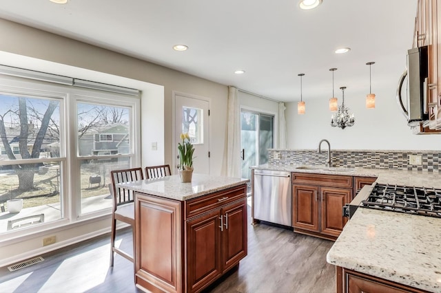 2023 N Shenandoah Dr, Arlington Heights, IL 60004 - kitchen featuring stainless steel appliances, healthy amount of natural light, a peninsula, wood finished floors, and recessed lighting