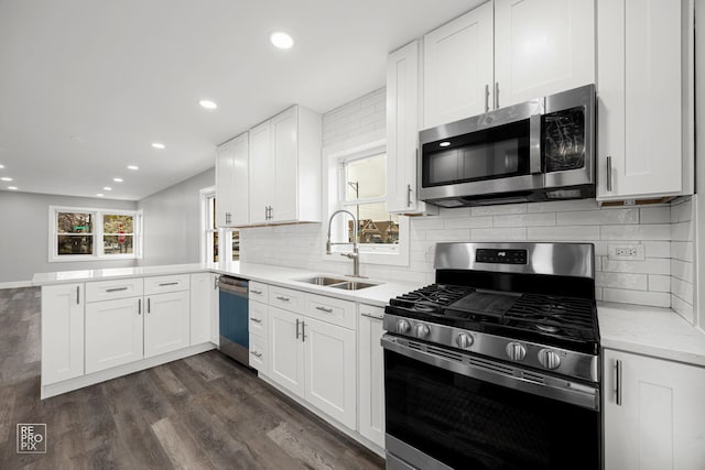 6158 S Austin Ave, Chicago, IL 60638 - kitchen with appliances with stainless steel finishes, a peninsula, white cabinetry, recessed lighting, and dark wood-type flooring