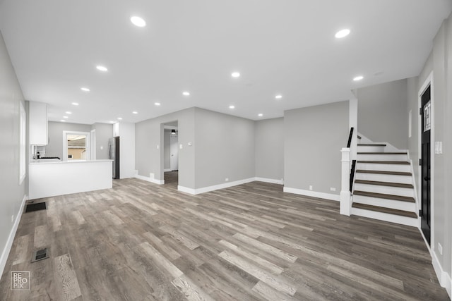 6158 S Austin Ave, Chicago, IL 60638 - unfurnished living room featuring wood finished floors, stairway, and recessed lighting