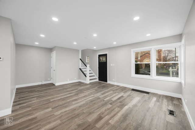 6158 S Austin Ave, Chicago, IL 60638 - unfurnished living room with stairs, wood finished floors, and recessed lighting