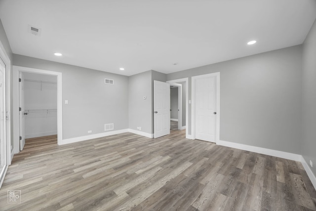 6158 S Austin Ave, Chicago, IL 60638 - unfurnished bedroom with light wood-type flooring, recessed lighting, and a walk in closet