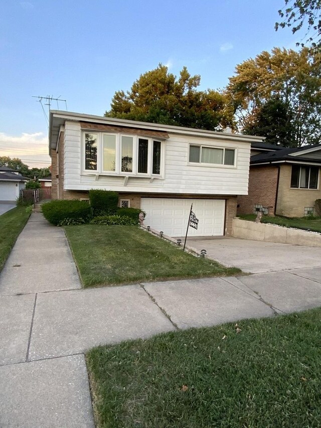 14441 Dante Ave, Dolton, IL 60419 - view of front of property featuring a garage, a front yard, driveway, and brick siding