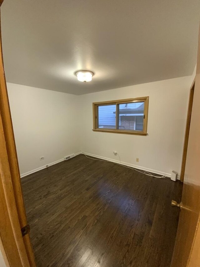 14441 Dante Ave, Dolton, IL 60419 - empty room featuring dark wood-type flooring and baseboards
