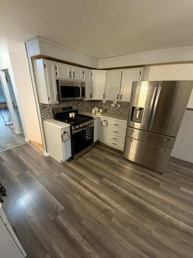 14441 Dante Ave, Dolton, IL 60419 - kitchen with appliances with stainless steel finishes, white cabinetry, backsplash, and dark wood-style floors